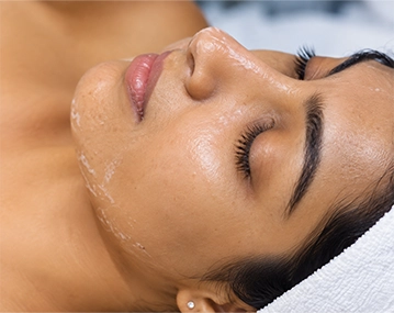 Indian woman receiving facial peeling treatment
