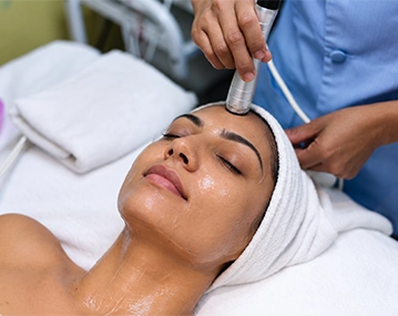 Indian woman receiving microdermabrasion treatment