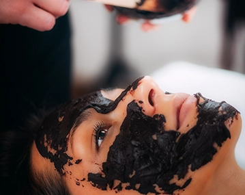 Indian woman receiving photo carbon skin treatment